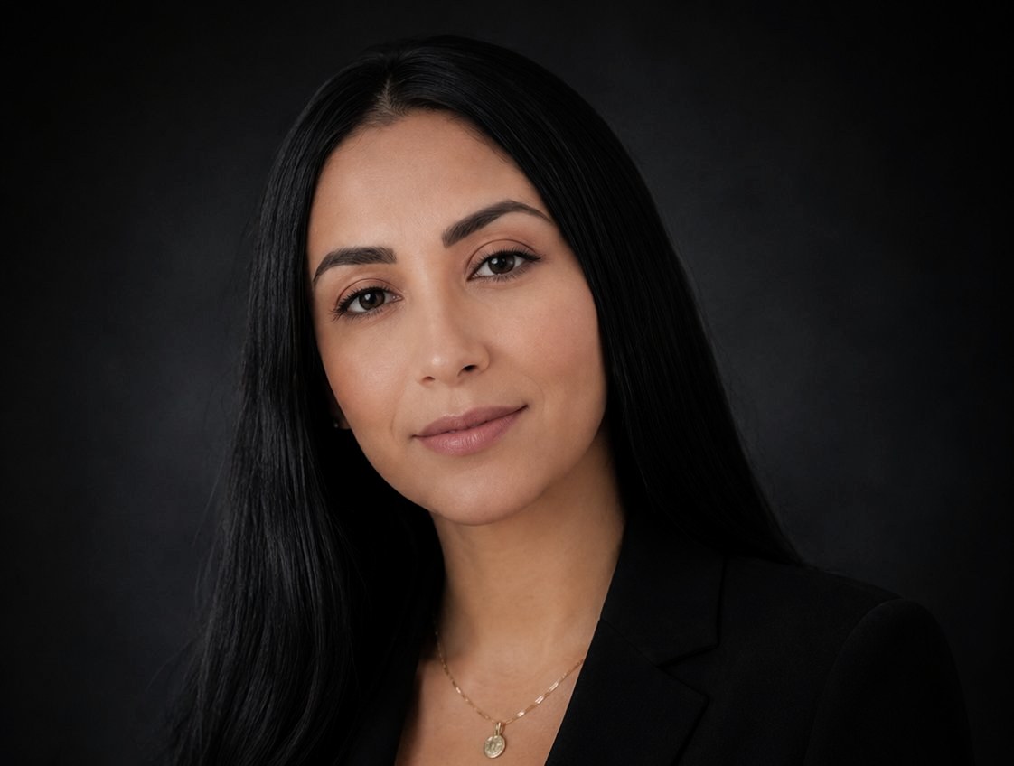 woman wearing a black blazer and a delicate gold necklace